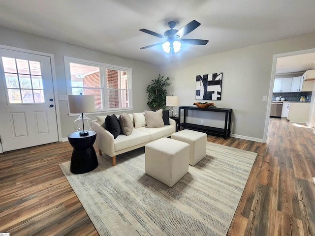 living room featuring ceiling fan, a healthy amount of sunlight, and dark hardwood / wood-style floors