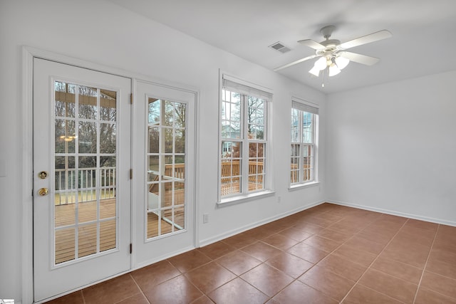 entryway featuring ceiling fan and tile patterned floors