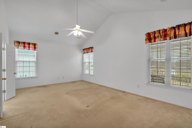 carpeted empty room featuring ceiling fan and vaulted ceiling