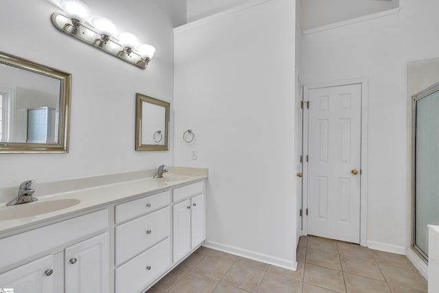 bathroom featuring a shower with shower door, vanity, ornamental molding, and tile patterned flooring