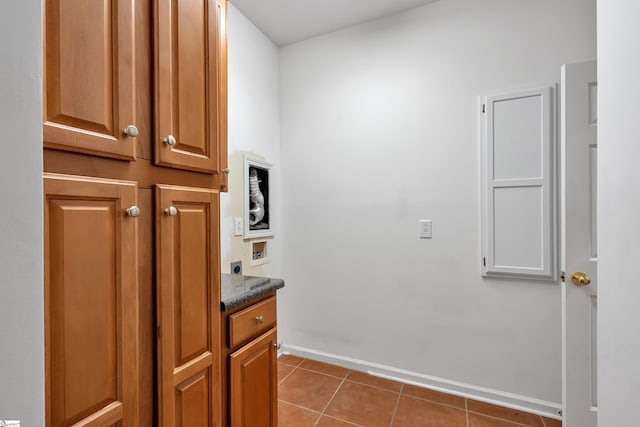 interior space featuring tile patterned flooring and hookup for an electric dryer