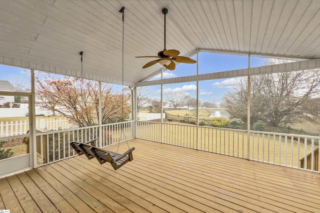 wooden deck featuring ceiling fan and a lawn