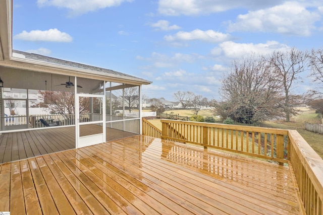 wooden terrace with ceiling fan and a sunroom