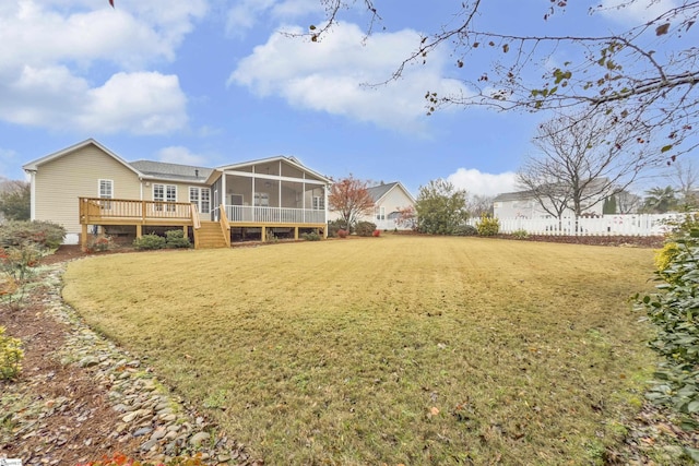 view of yard with a wooden deck and a sunroom