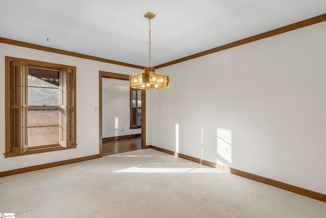 spare room with ornamental molding, a chandelier, and carpet floors