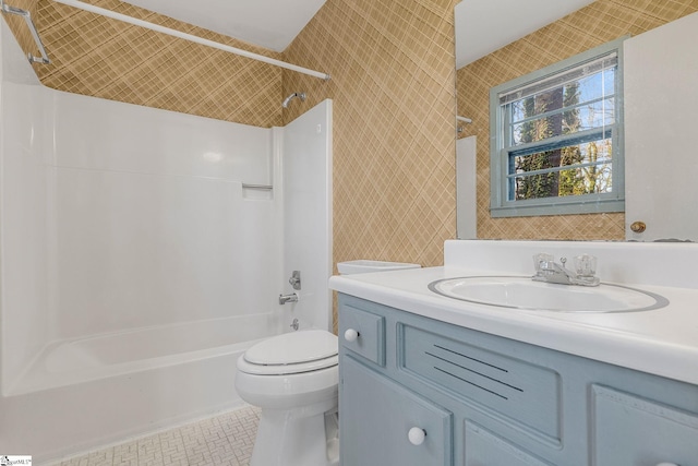 full bathroom featuring tile patterned floors, toilet, vanity, and bathing tub / shower combination