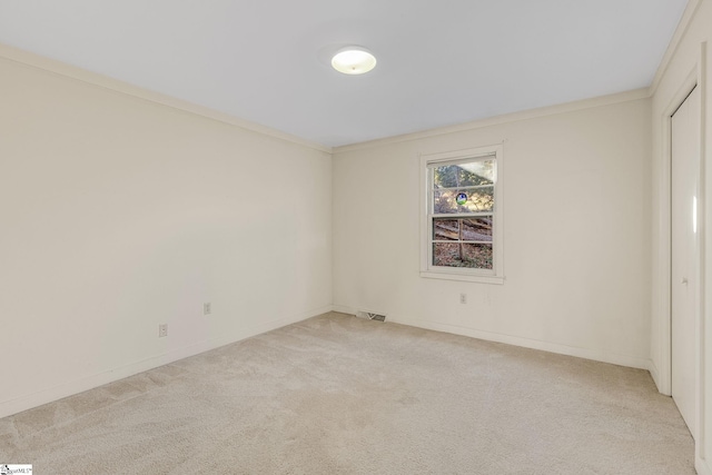 empty room with light carpet and ornamental molding