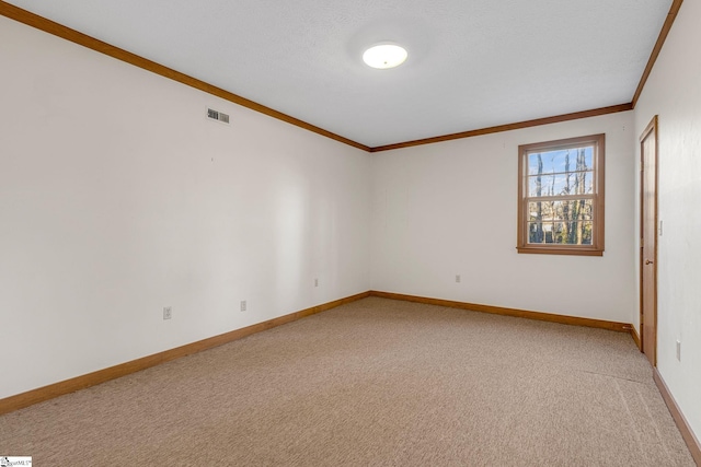 carpeted spare room with crown molding