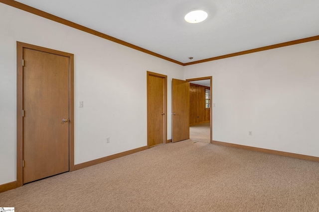 carpeted spare room featuring ornamental molding