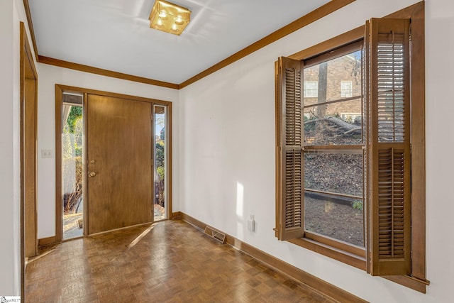 entrance foyer with parquet flooring, a wealth of natural light, and ornamental molding