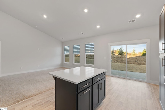 kitchen featuring a kitchen island and light hardwood / wood-style flooring