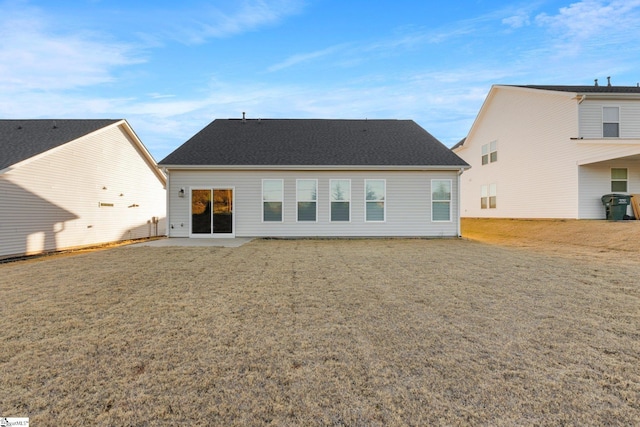 rear view of property featuring a yard and a patio