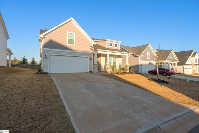 view of front of home featuring a front lawn, a porch, and a garage