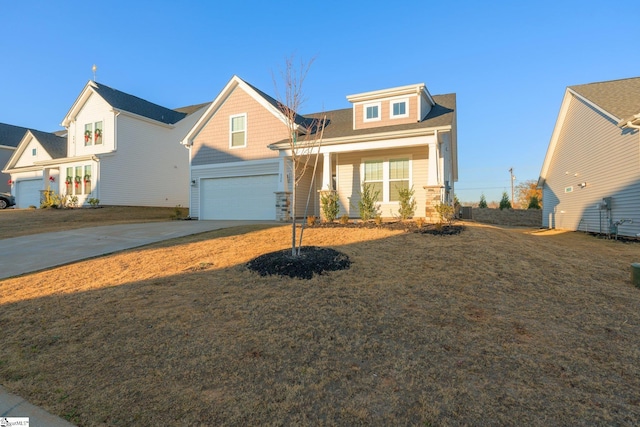 view of front facade featuring a front yard, covered porch, and a garage