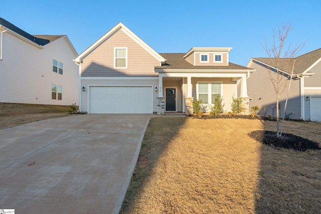 view of front of house featuring a front lawn, covered porch, and a garage