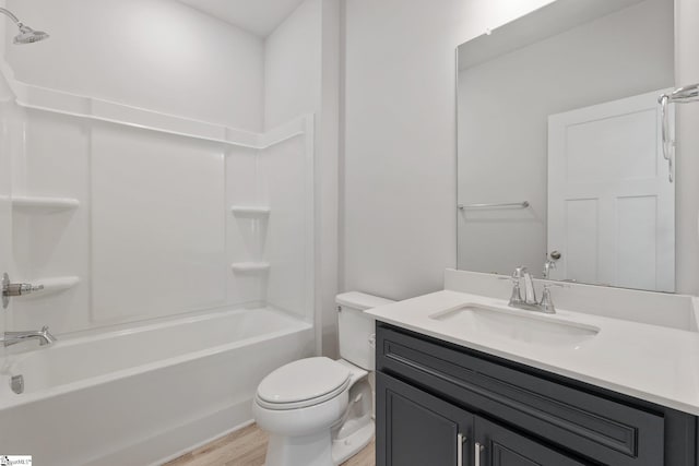 full bathroom with washtub / shower combination, toilet, wood-type flooring, and vanity