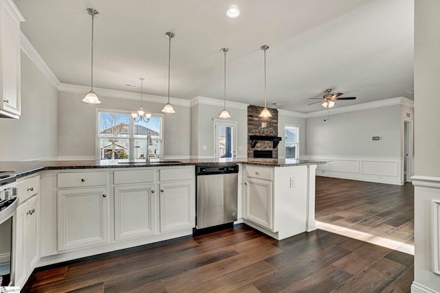 kitchen with stainless steel dishwasher, dark stone countertops, ceiling fan with notable chandelier, white cabinets, and sink