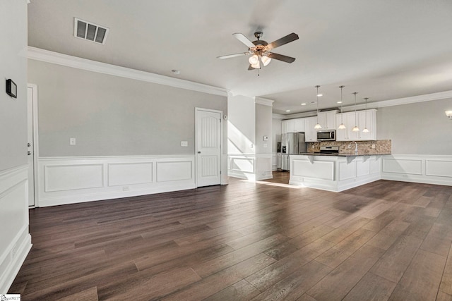 unfurnished living room with sink, dark hardwood / wood-style floors, and crown molding