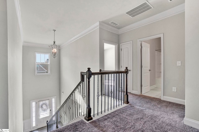 hallway featuring light colored carpet, a notable chandelier, and ornamental molding