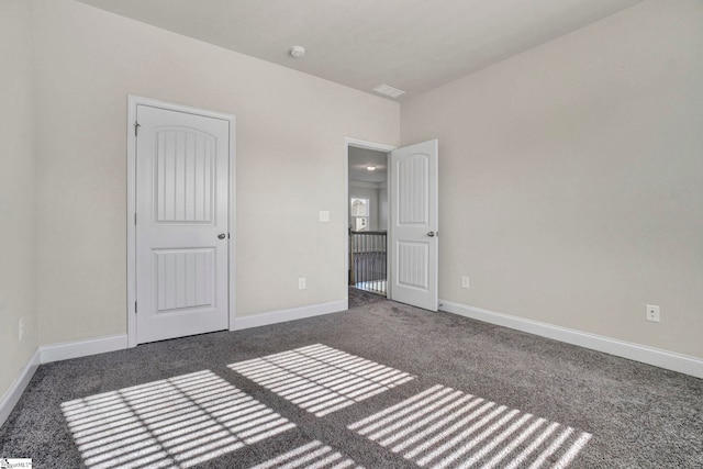 unfurnished bedroom featuring dark carpet