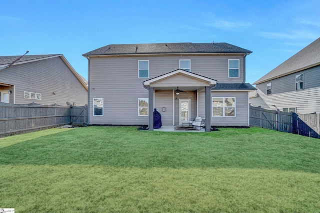 back of property with a patio area and a yard