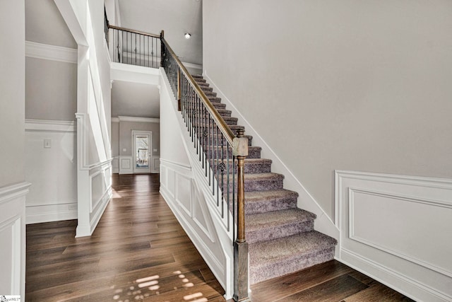 stairs with crown molding and hardwood / wood-style flooring