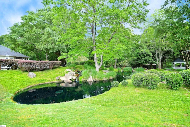 view of yard with a gazebo and a water view