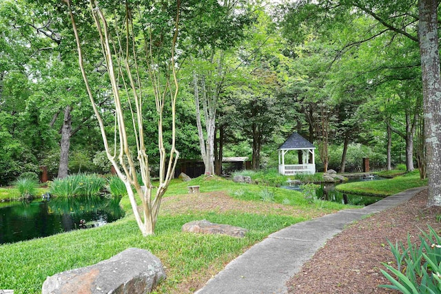 view of yard with a gazebo and a water view