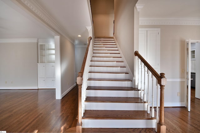 staircase featuring crown molding and wood-type flooring