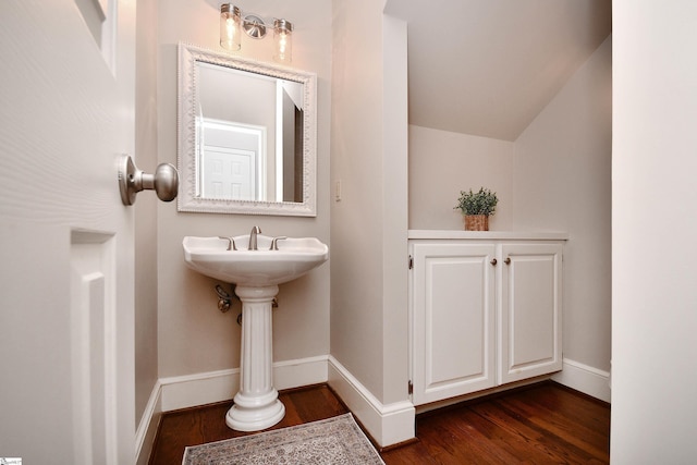 bathroom featuring lofted ceiling and hardwood / wood-style flooring