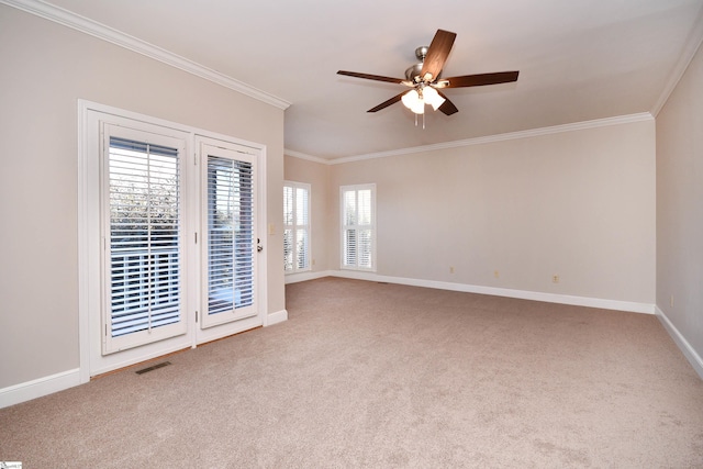 spare room with ceiling fan, a healthy amount of sunlight, crown molding, and carpet flooring