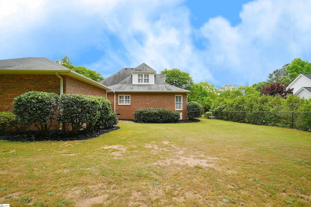 view of side of property with a yard