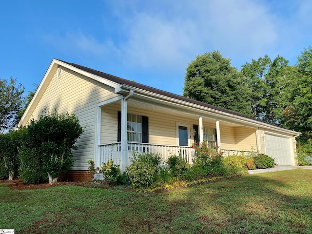 ranch-style home featuring a garage, a front yard, and a porch