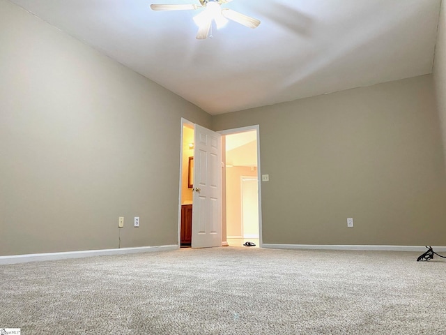 carpeted spare room with ceiling fan