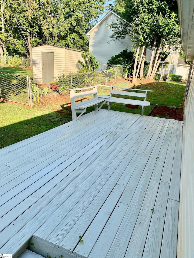 deck featuring a lawn and a shed