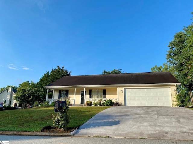 view of front of home featuring a front yard, a garage, and a porch