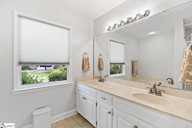 bathroom featuring a bath, tile patterned floors, and vanity