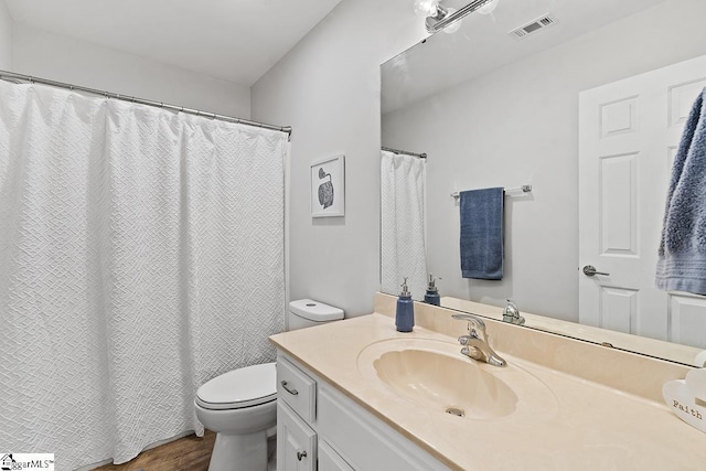 bathroom with wood-type flooring, toilet, and vanity