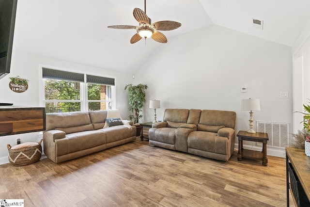 living room with ceiling fan, wood-type flooring, and high vaulted ceiling