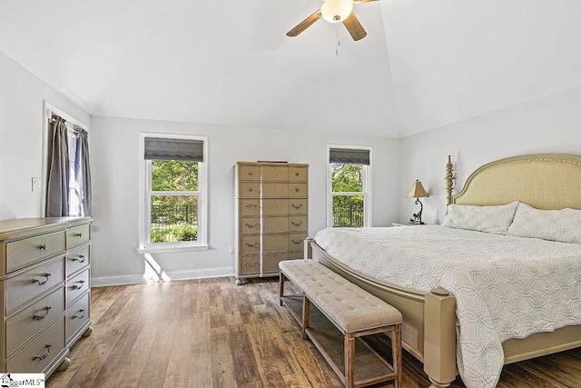 bedroom with dark wood-type flooring, ceiling fan, and lofted ceiling