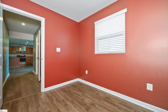 spare room with dark hardwood / wood-style flooring