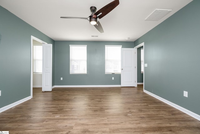 unfurnished bedroom featuring ceiling fan and dark hardwood / wood-style flooring