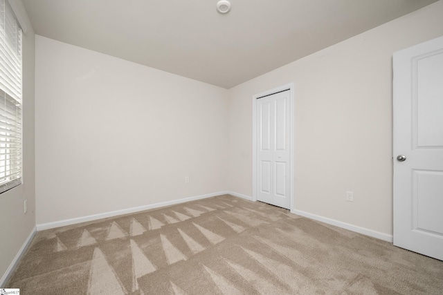 unfurnished bedroom with light carpet