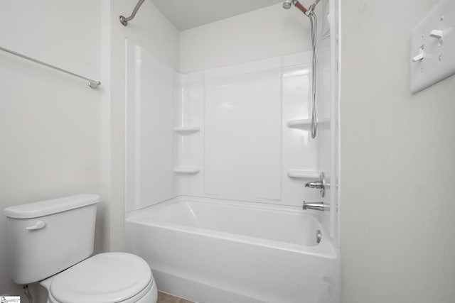 bathroom with tub / shower combination and toilet