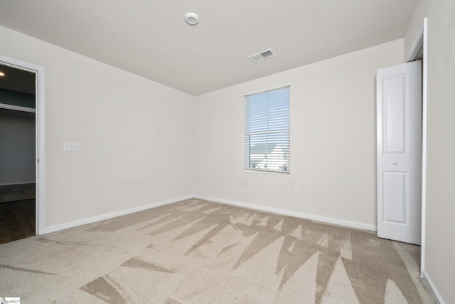 unfurnished bedroom with light carpet and a closet