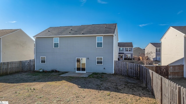 back of house with a patio area and a yard