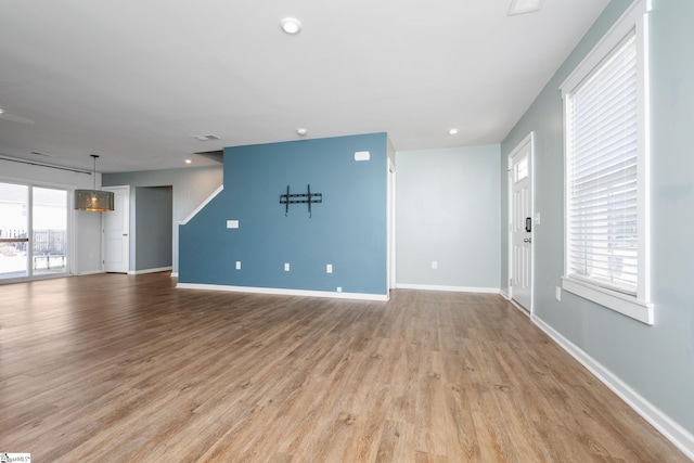 unfurnished living room featuring light wood-type flooring