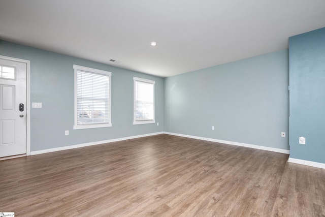 spare room with light hardwood / wood-style floors