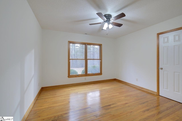 spare room featuring light hardwood / wood-style floors, a textured ceiling, and ceiling fan