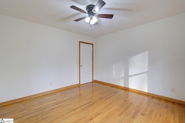 unfurnished room with ceiling fan, a textured ceiling, and hardwood / wood-style flooring